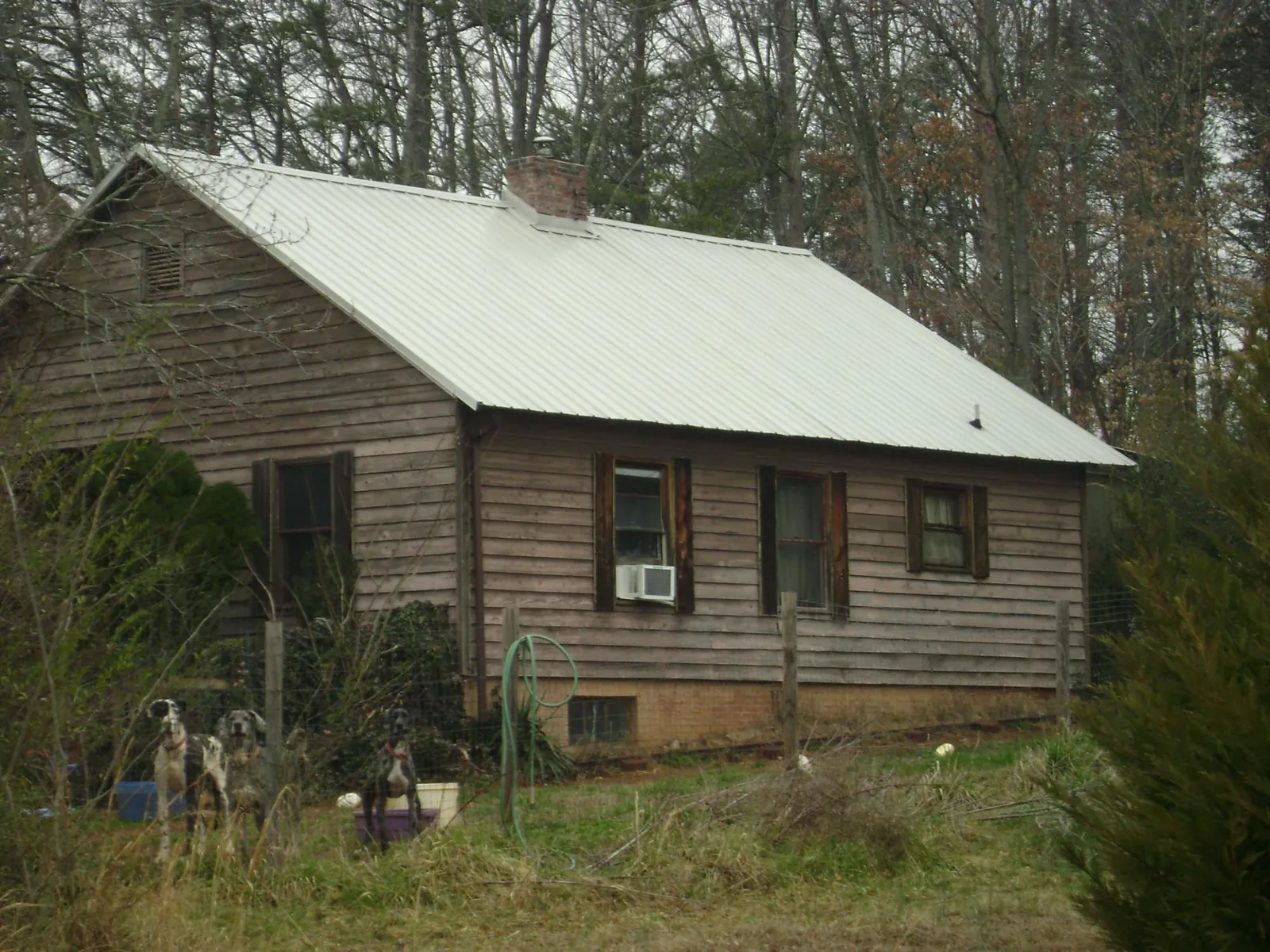 White metal roof on an old wood sided farmhouse, from a Metal Roof Installation job in Sumner